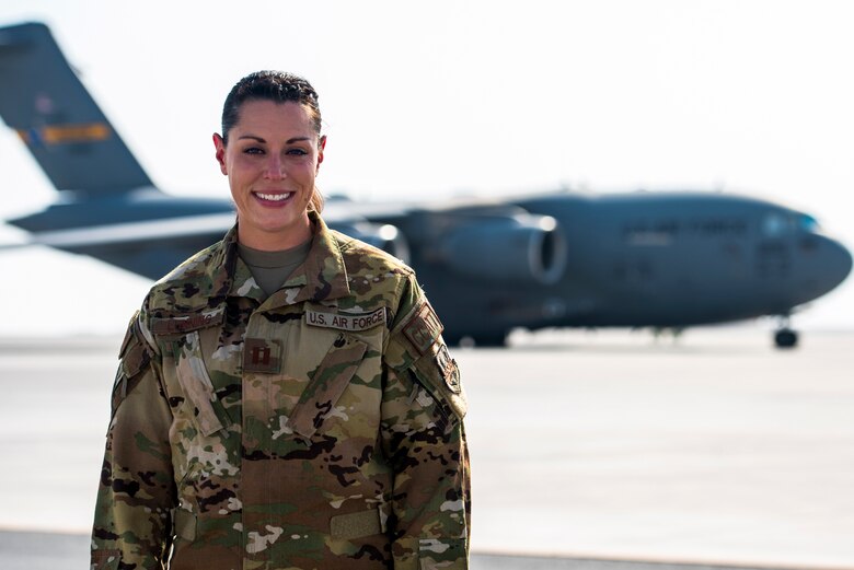 Captain Katie Lunning, 379th Expeditionary Aeromedical Evacutation Squadron critical care air transport team registered nurse stands infront of a C-17 Globemaster III Oct. 13, 2021, at Al Udeid Air Base, Qatar.