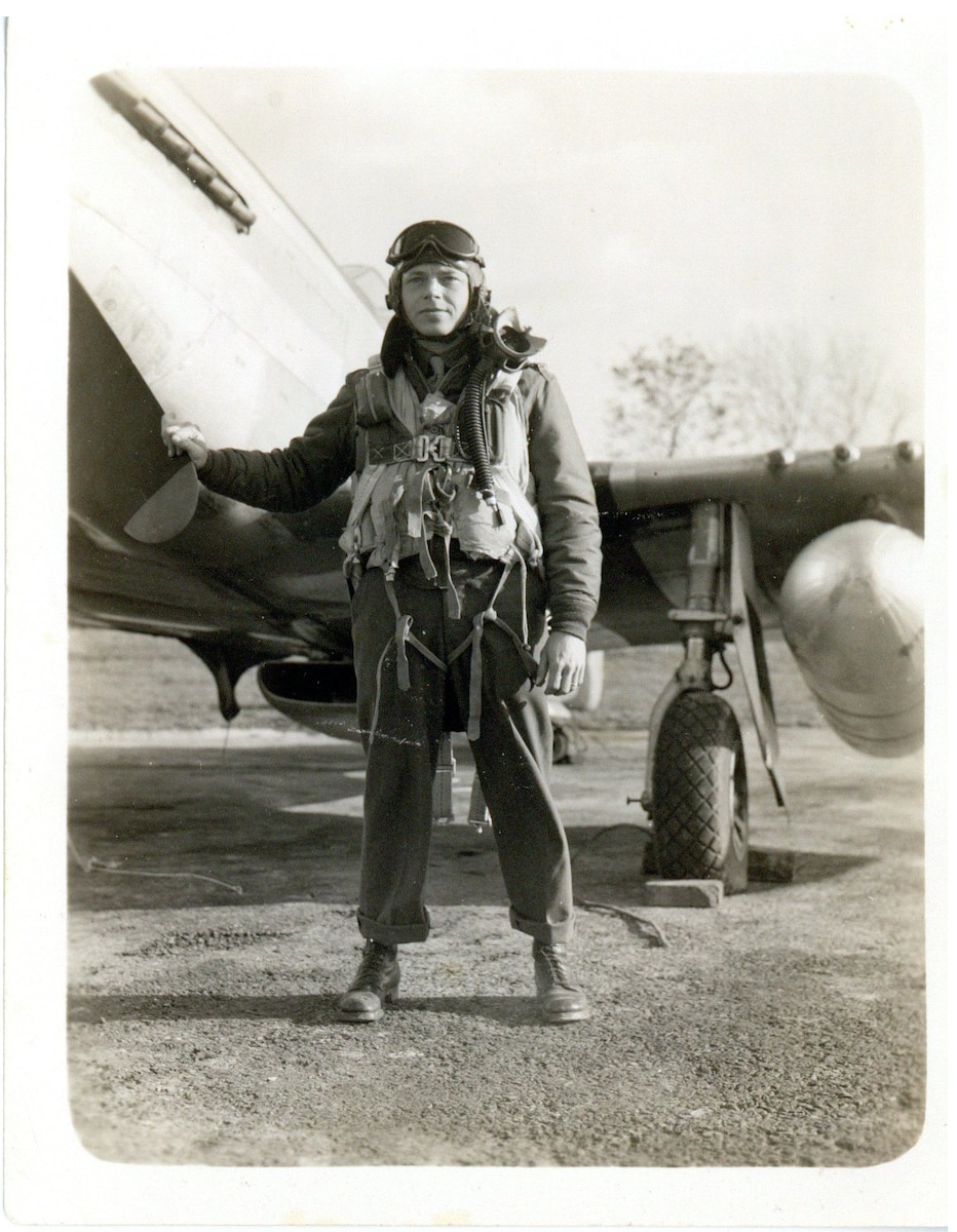 Pilot standing next to an aircraft.