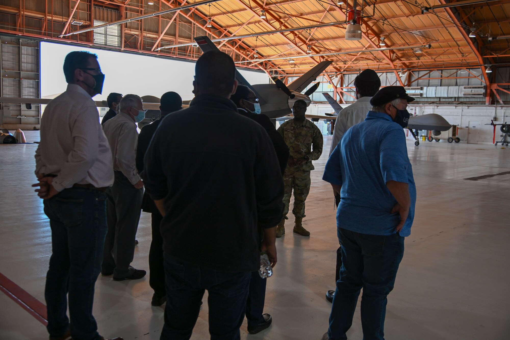 2nd Lt. Khadarryl Johnson, 49th Aircraft Maintenance Squadron section commander, gives tour of a MQ-9 Reaper hangar to local clergy during a Clergy Day event, Nov. 4, 2021, on Holloman Air Force Base, New Mexico. During the visit, local clergy members were oriented with Holloman’s MQ-9 mission to better understand the experiences of 49th Wing Airmen and Guardians. (U.S. Air Force photo by Airman 1st Class Jessica Sanchez-Chen)