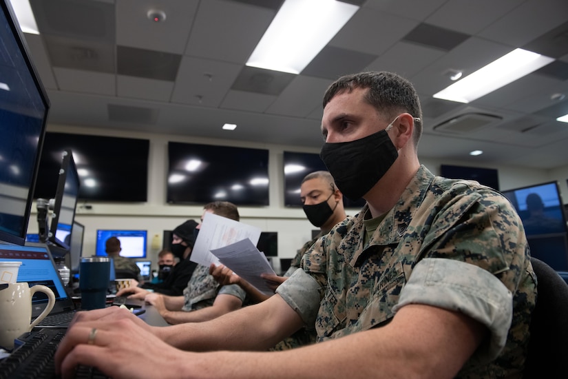 Marines type on laptops.
