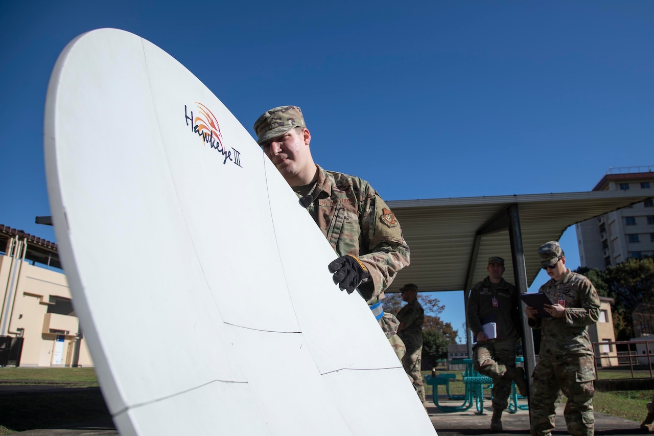 An airman inspects cyber gear.