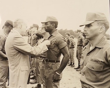 Newt Oliphant, center, is pictured receiving his Expert Field Medical Badge in 1979. Oliphant, now a civilian employee for the U.S. Army Medical Materiel Agency, served 20 years on active duty, retiring at the rank of major in 2001. (Courtesy Newt Oliphant)