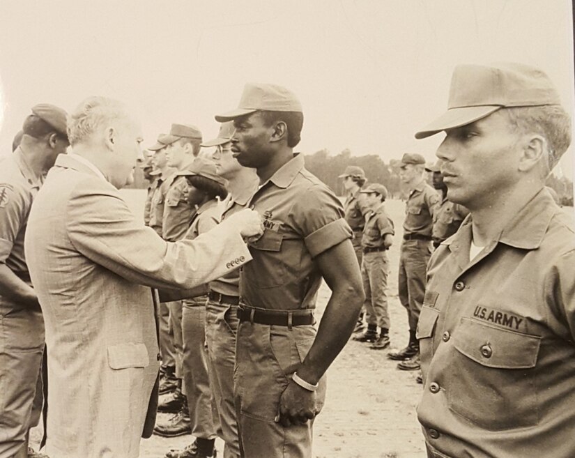 Newt Oliphant, center, is pictured receiving his Expert Field Medical Badge in 1979. Oliphant, now a civilian employee for the U.S. Army Medical Materiel Agency, served 20 years on active duty, retiring at the rank of major in 2001. (Courtesy Newt Oliphant)