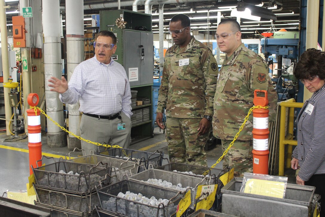 Three men (two military) and one woman view items at  the Jenkintown, Pennsylvania facility.
