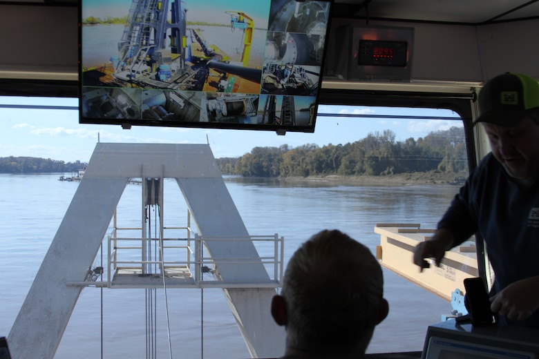 In the control tower of the Dredge Goetz, Maj. John Chambers views the data screen showing the different features of the dredging controls. Ship masters from the Goetz instructed him on the basic operations of the dredging crane and agitator.