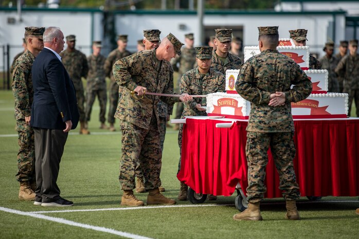 U.S. Marine Corps Col. Curtis V. Ebitz, center, commanding officer, Marine Corps Air Station New River cuts the cake during the 246th Marine Corps Birthday Cake Cutting Ceremony on MCAS New River, North Carolina, Nov. 10, 2021. A celebration for the Marine Corps birthday is held every year to reflect on the traditions, history and legacy of the Marine Corps. (U.S. Marine Corps photo by Lance Cpl. Isaiah Gomez)