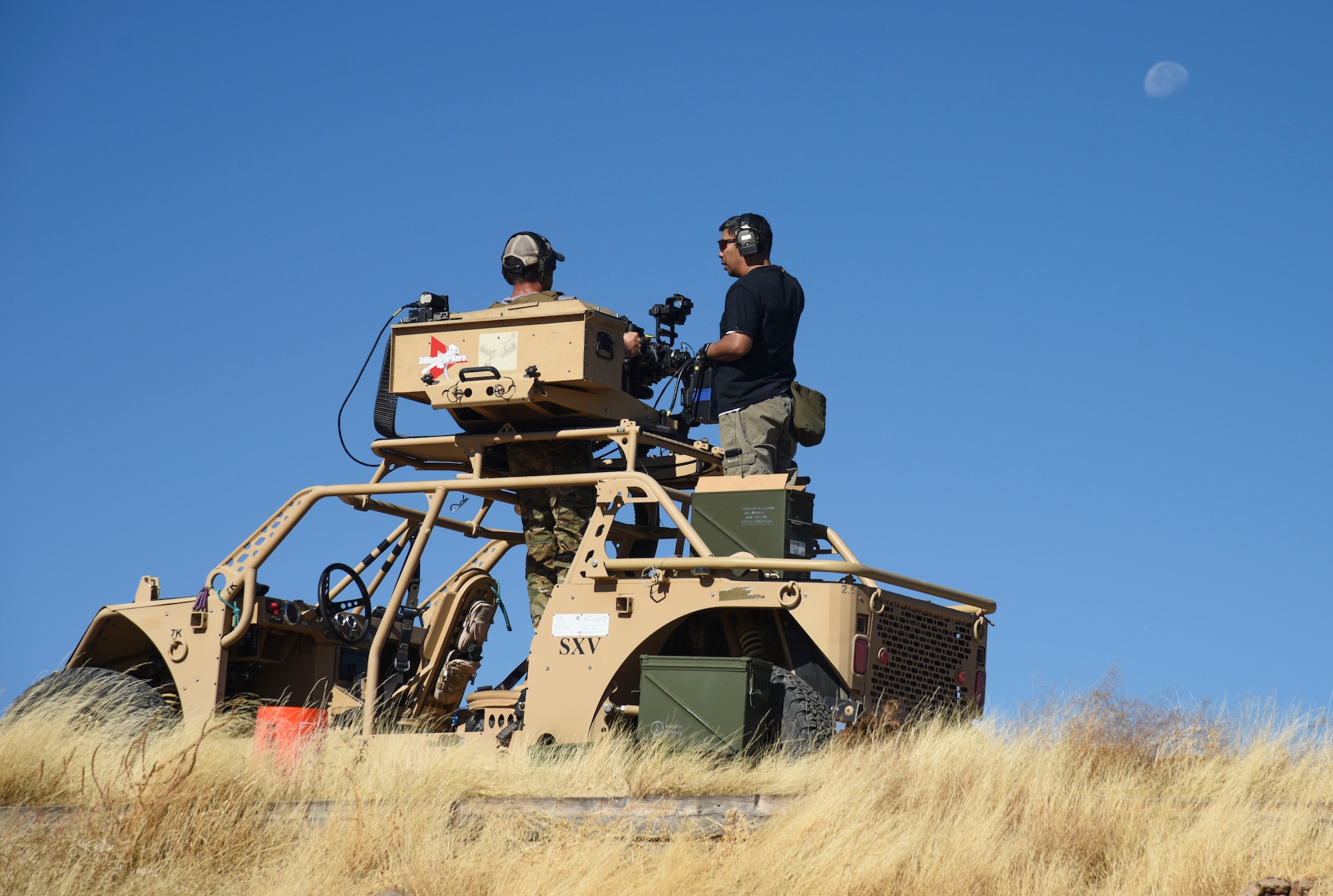 Pictured above is a man shooting a mounted gun from a vehicle.