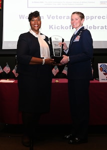 Joint Base Anacostia-Bolling Commander Col. Cat Logan (Right) accepts an award from Women Veterans ROCK National Campaign Chair Deborah Harmon-Pugh during the Women in Legendary Leadership luncheon at the National Guard Museum on Nov. 7, 2021 in Washington, D.C. The coalition of women veteran and women advocacy organizations aims to empower and encourage active military members, veterans, military spouses and widows, and young women in their local communities to become effective leaders, connecting them with mentorship and resources, and hosting a number of regular events. (U.S. Air Force photo by Staff Sgt. Kayla White)