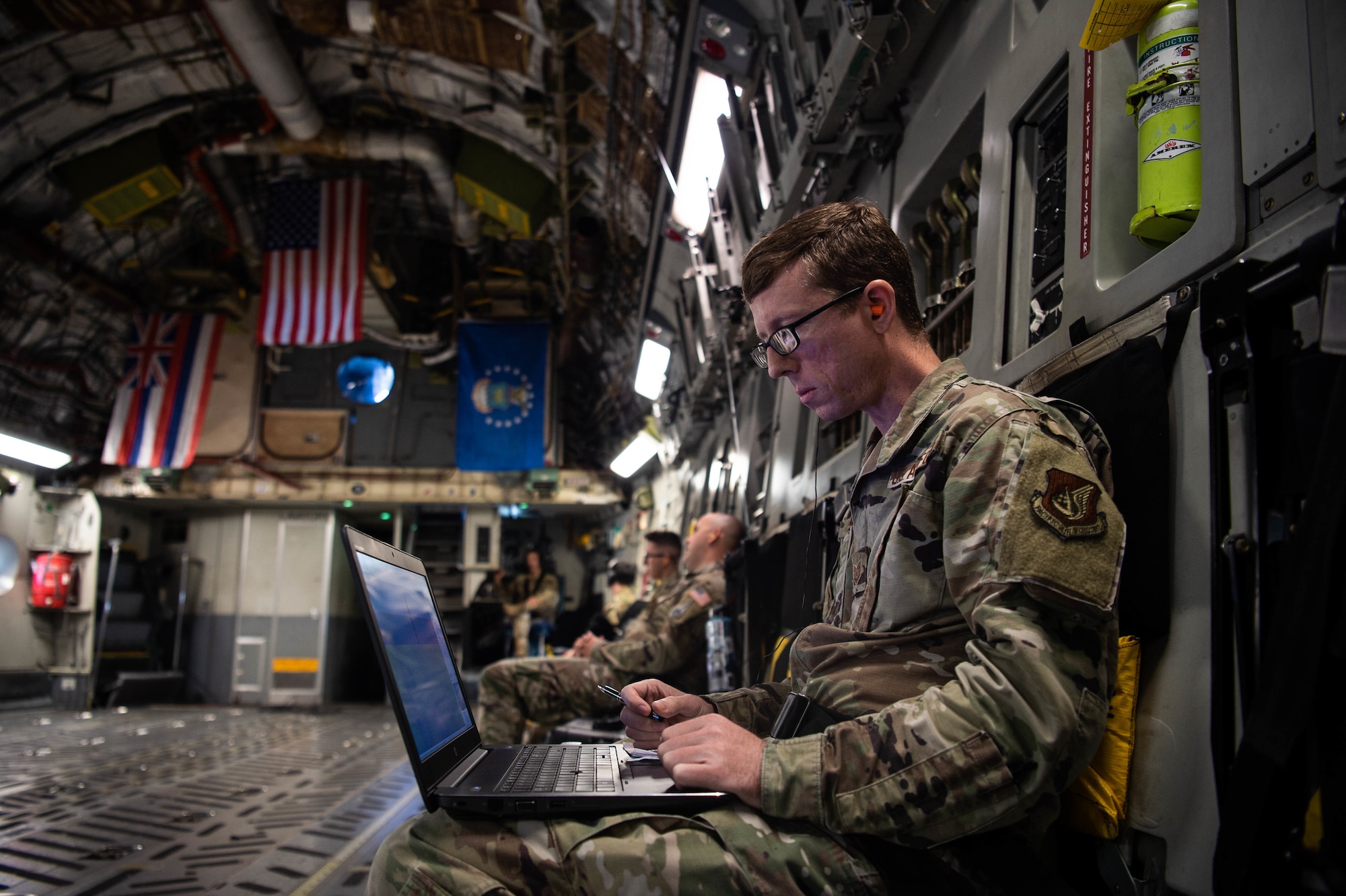 Tech. Sgt. Carl Williams, 747th Cyberspace Squadron standards and evaluations craftsman, observes radio frequencies recorded by a stand-alone hub activity reconnaissance kit in a C-17 Globemaster III around the Hawaiian Islands, Nov. 3, 2021. The end goal of the “SHARK” kit is to be able to detect and cancel radio frequency jamming. (U.S. Air Force photo by Staff Sgt. Alan Ricker)