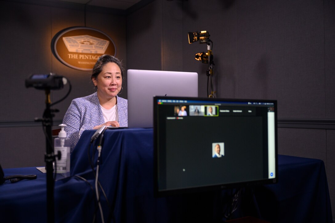 A woman speaks at a virtual conference.