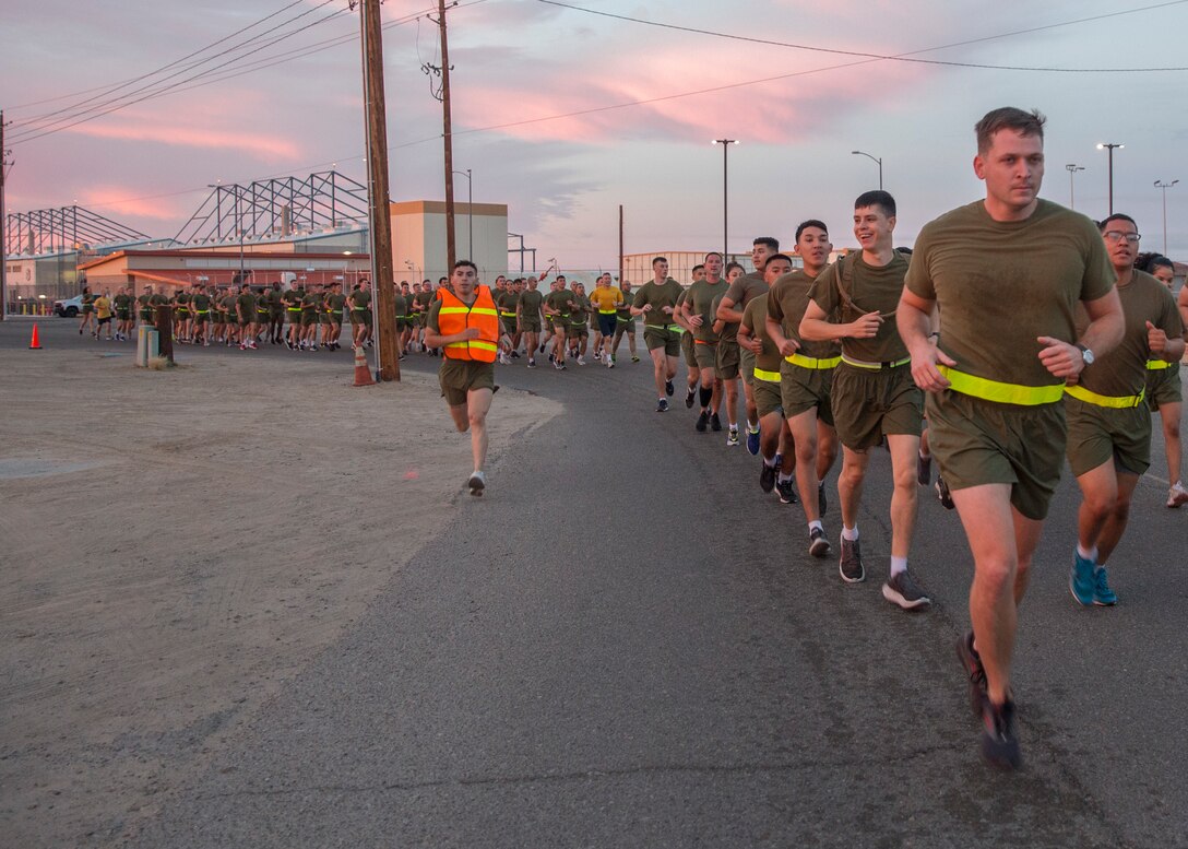 U.S. Marines with Headquarters and Headquarters Squadron (H&HS) participate in a unit run at Marine Corps Air Station Yuma, Ariz., Nov. 9, 2021. The run was in celebration of the 246th Marine Corps birthday and was intended to strengthen esprit de corps and camaraderie amongst Marines and Sailors of H&HS. (U.S. Marine Corps photo by Sgt. Jason Monty)