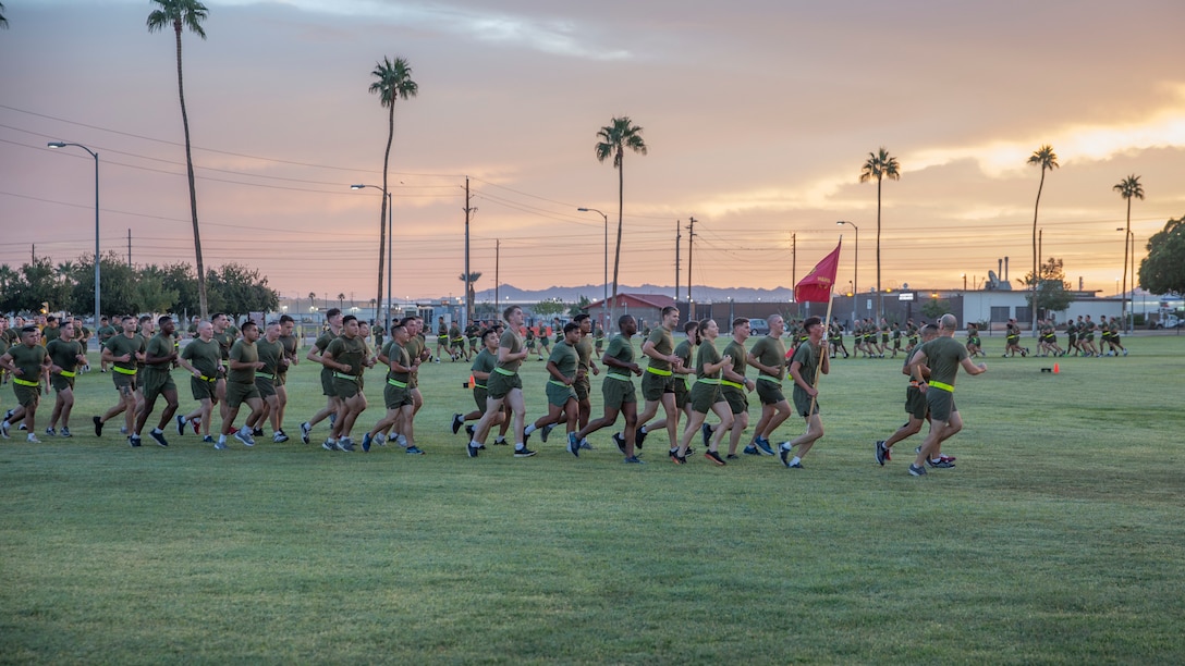 U.S. Marines with Headquarters and Headquarters Squadron (H&HS) participate in a unit run at Marine Corps Air Station Yuma, Ariz., Nov. 9, 2021. The run was in celebration of the 246th Marine Corps birthday and was intended to strengthen esprit de corps and camaraderie amongst Marines and Sailors of H&HS. (U.S. Marine Corps photo by Sgt. Jason Monty)