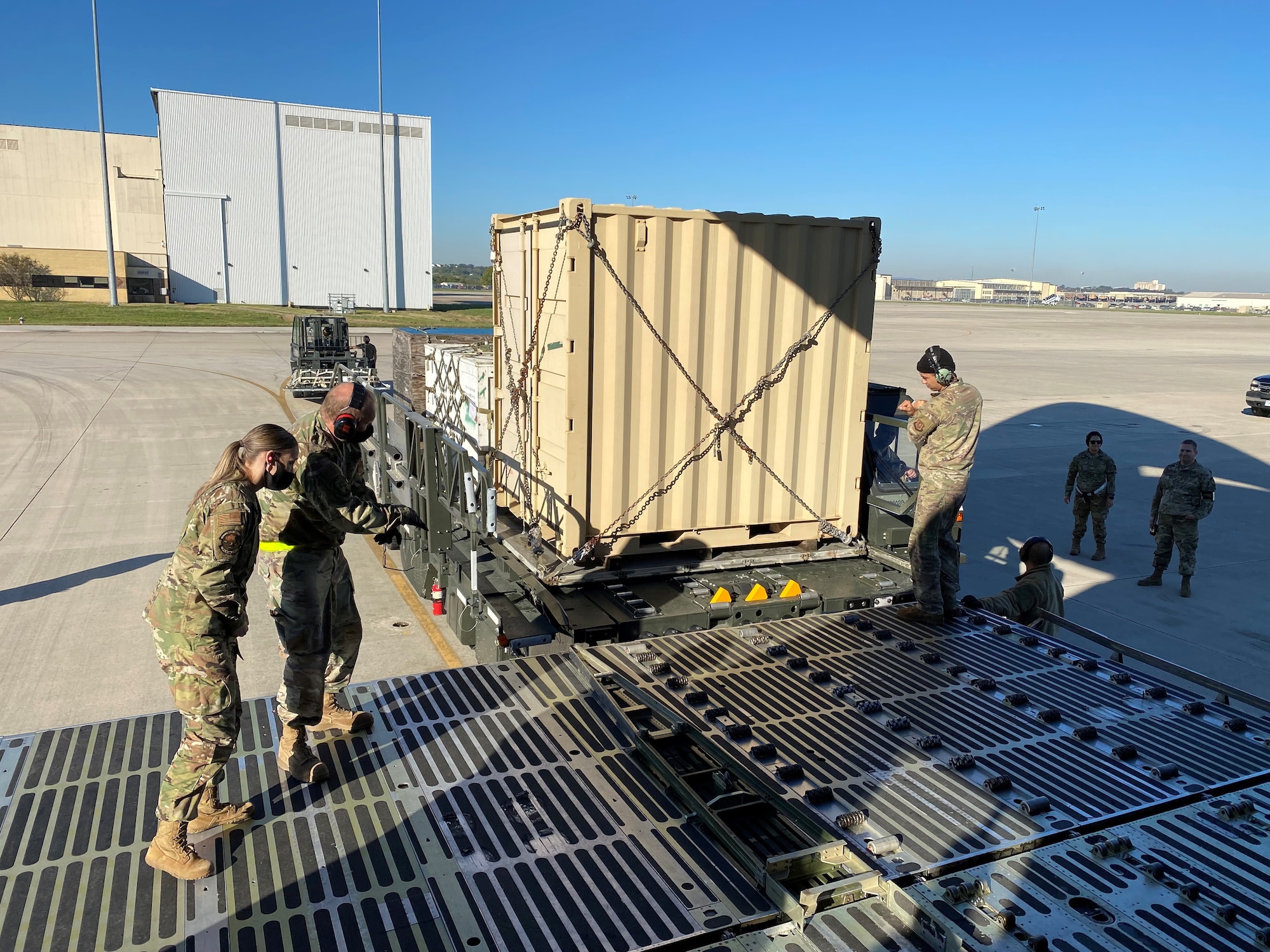Reserve Citizen Airmen prepare to push an ISU-90 cargo container into the cargo area of a C-5M Super Galaxy aircraft Nov. 7, 2021 at Joint Base San Antonio-Lackland, Texas. This activity was part of a multi-unit cargo preparation and loading training event. (Courtesy photo by Tech. Sgt. John Shue)
