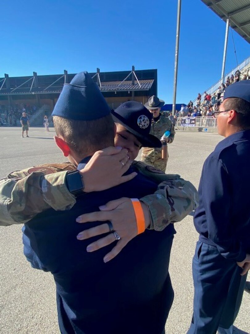 MTI hugs her husband after he graduates from BMT