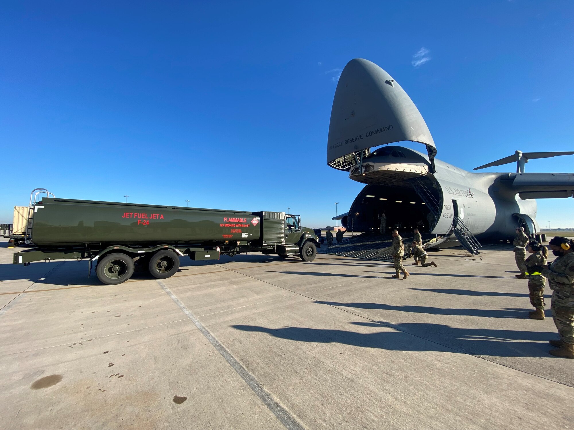Reserve Citizen Airmen with the 433rd Airlift Wing load a fuel delivery truck onto a C-5M Super Galaxy cargo aircraft during a total force training event Nov. 7, 2021 at Joint Base San Antonio-Lackland, Texas. The training involved several units within the 433rd AW and 502nd Air Base Wing to provide a greater variety of experiences and interaction than when the units train independently. (Courtesy photo by Tech. Sgt. John Shue)