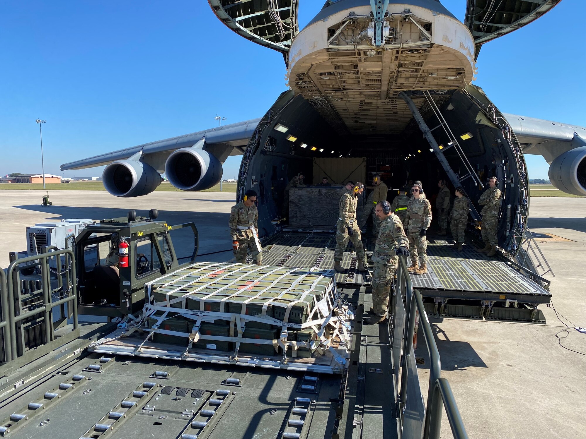 Reserve Citizen Airmen with the 433rd Airlift Wing prepare to load palletized cargo onto a C-5M Super Galaxy aircraft during a training exercise Nov. 7, 2021 at Joint Base San Antonio-Lackland, Texas. Multiple 433rd AW units and an active-duty unit participated in the exercise to build relationships and create a greater training opportunity than when units train individually. (Courtesy photo by Tech. Sgt. John Shue)