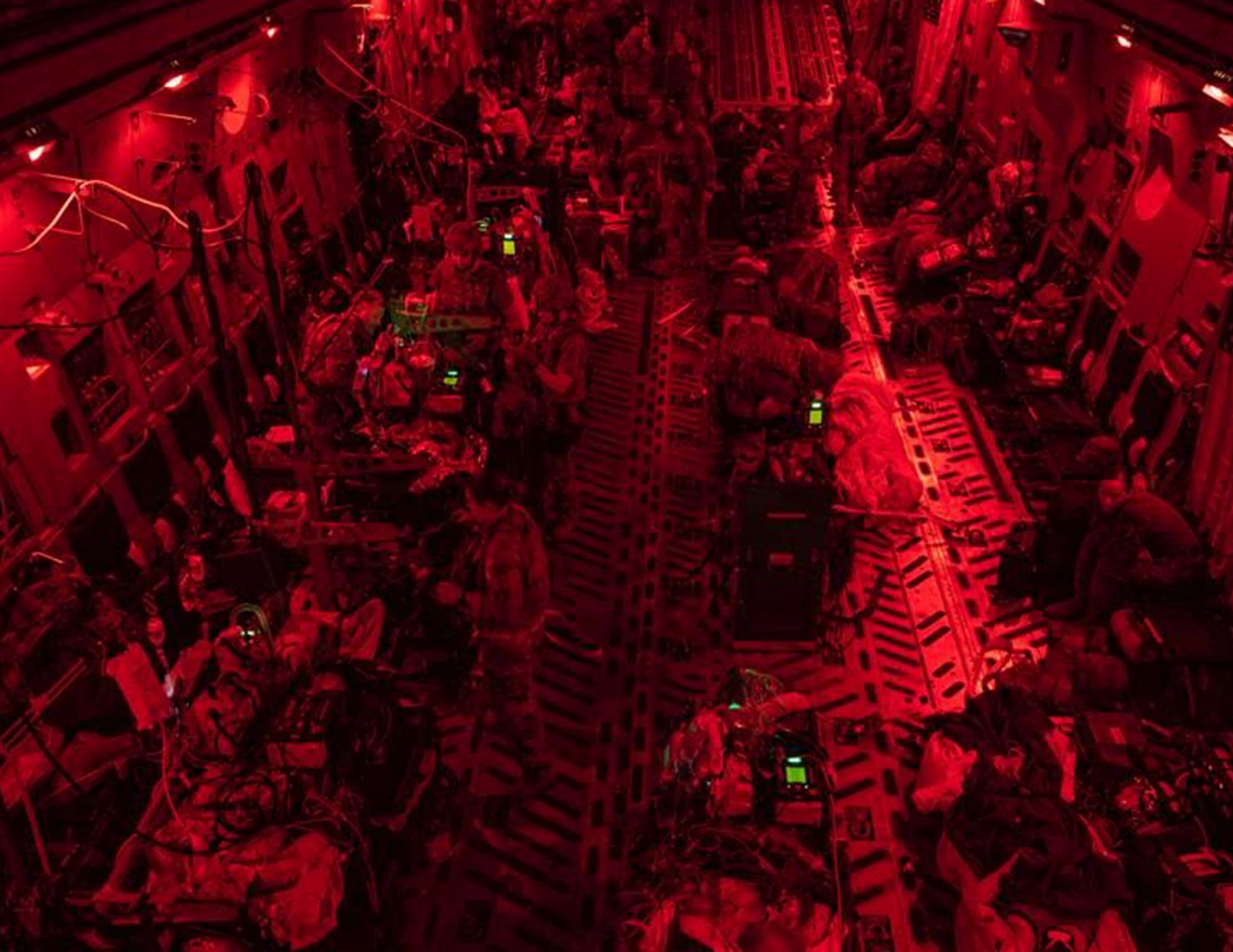 U.S. Air Force Airmen from the 379th Expeditionary Aeromedical Evacuation Squadron provide medical care on a C-17 Globemaster III over the skies of U.S. Central Command, Aug. 26, 2021.