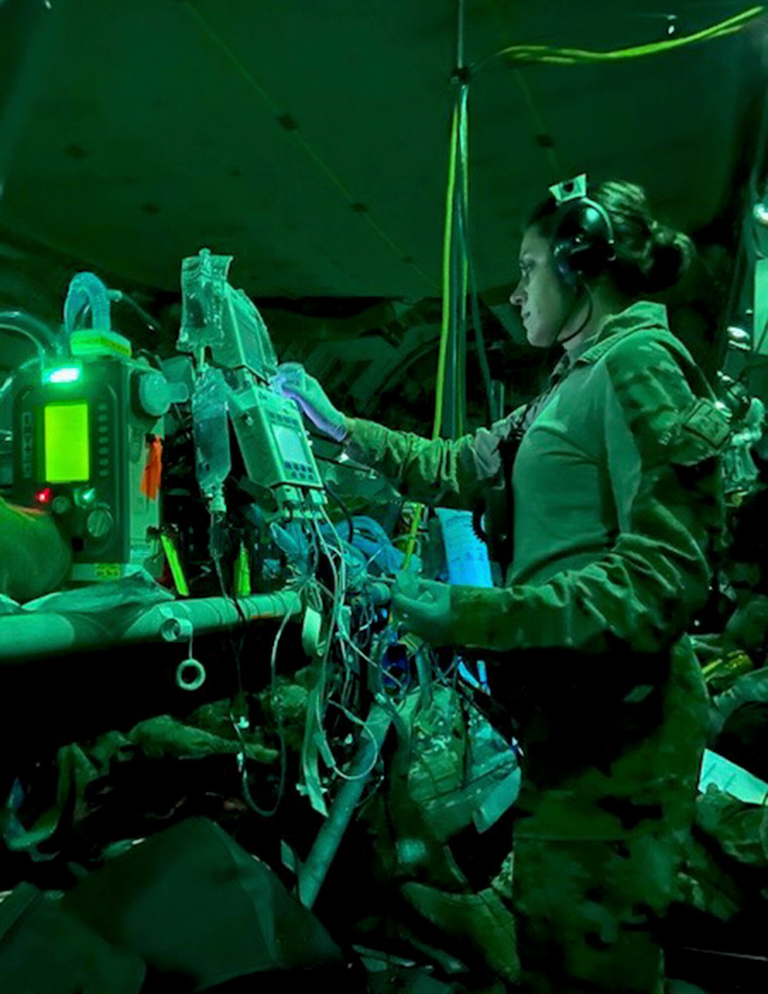 U.S. Air Force Capt. Katie Lunning, center, 379th Expeditionary Aeromedical Evacuation Squadron, critical care air transport team registered nurse, checks equipment on a C-17 Globemaster III in Kabul, Afghanistan, Aug. 20, 2021.