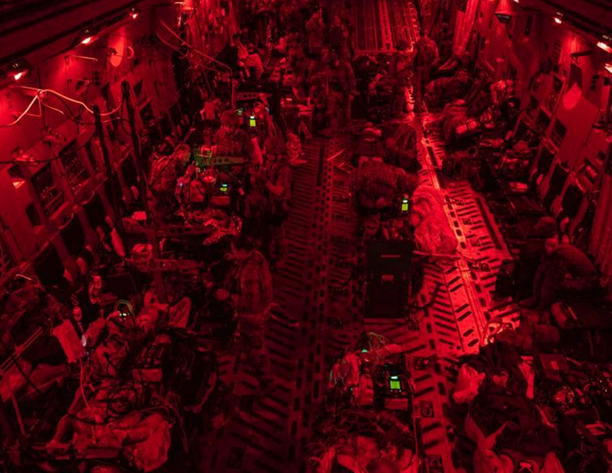 U.S. Air Force Airmen from the 379th Expeditionary Aeromedical Evacuation Squadron provide medical care on a C-17 Globemaster III over the skies of U.S. Central Command, Aug. 26, 2021.