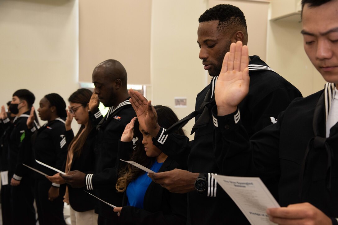 Six Sailors and four family members representing six different countries including China, Colombia, Haiti, Nigeria, South Korea, and the Philippines, recite the Oath of Allegiance during a naturalization ceremony held by Region Legal Service Office Western Pacific, Legal Assistance Department, at Commander, Fleet Activities Yokosuka's (CFAY) Chapel of Hope.