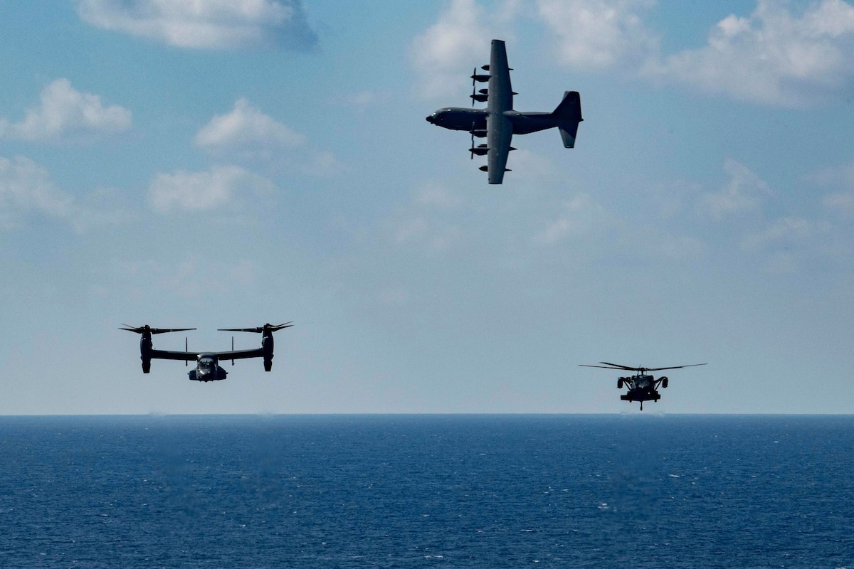 An MC-130J Air Commando II and a CV-22 Osprey both assigned to the 353rd Special Operations Wing fly alongside a Japanese Air Self Defense Force UH-60J assigned to Naha Air Rescue on Nov 9, 2021 during a search and rescue exercise. The purpose of this training is to enhance the Japan-U.S. bilateral response capabilities to real-world emergencies. (U.S. Air Force Photo by A1C Moses Taylor)