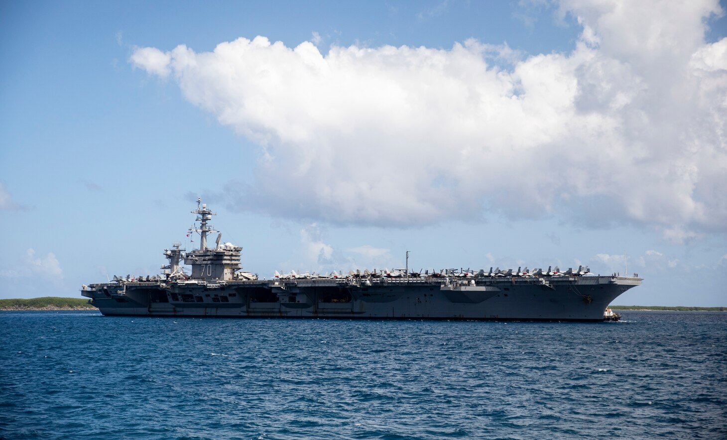 APRA HARBOR, Guam (Nov. 11, 2021) – The Nimitz-class aircraft carrier USS Carl Vinson (CVN 70) arrives at Guam for a port visit. The arrival of Carl Vinson Carrier Strike Group marks the first time that a carrier strike group with the advanced capabilities of the F-35C Lightning II and Navy CMV-22B Osprey have visited Guam. Carl Vinson Strike Group is on a scheduled deployment in the U.S. 7th Fleet area of operations to enhance interoperability through alliances and partnerships while serving as a ready response force in support of a free and open Indo-Pacific region. (U.S. Navy photo by Mass Communication Specialist 1st Class Devin M. Langer)