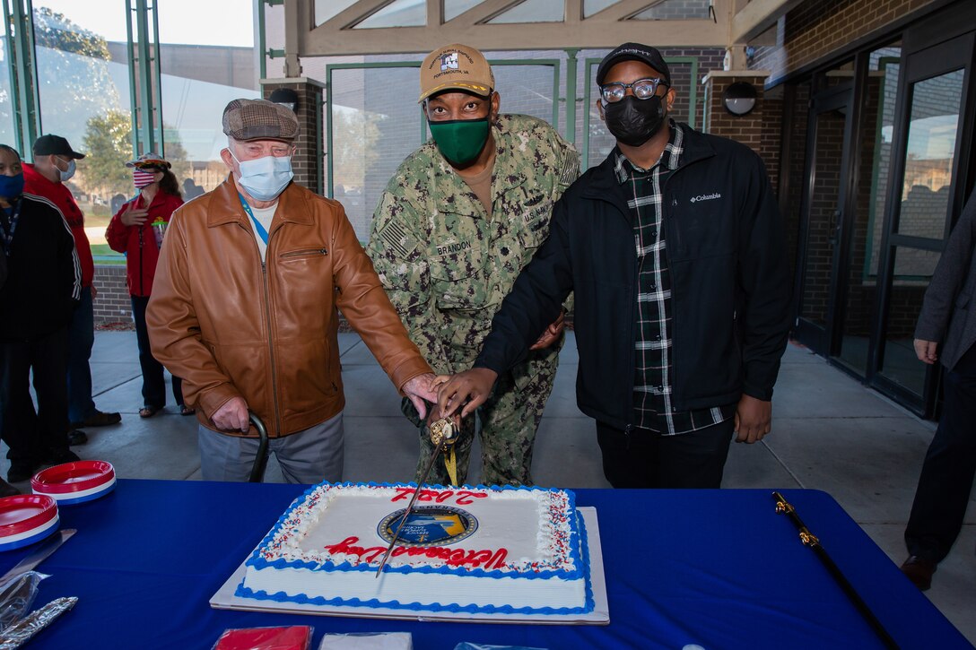 Brandon hosted a cake cutting ceremony with Oscar Thorpe and Ernest J. Scott III during Norfolk Naval Shipyard’s (NNSY) annual Veterans Day Fall-In for Colors Nov. 10, paying tribute to all veterans spanning generations and employed at America’s Shipyard. The cake cutting ceremony is a time-honored tradition in the military celebrating the past, present, and future of our Nation and those who serve to protect it.