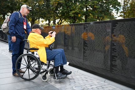 Peter Jones, a retired U.S. Army Soldier from Mount Pleasant, Iowa, and Michael Downey, a tour group volunteer, view the Vietnam Veterans Memorial in Washington D.C., Nov. 4, 2021. Jones, who served in Vietnam from 1968-1969, was in the Army and Iowa Army National Guard and was part of a group of veterans from Illinois and Iowa who visited the nation’s capital.