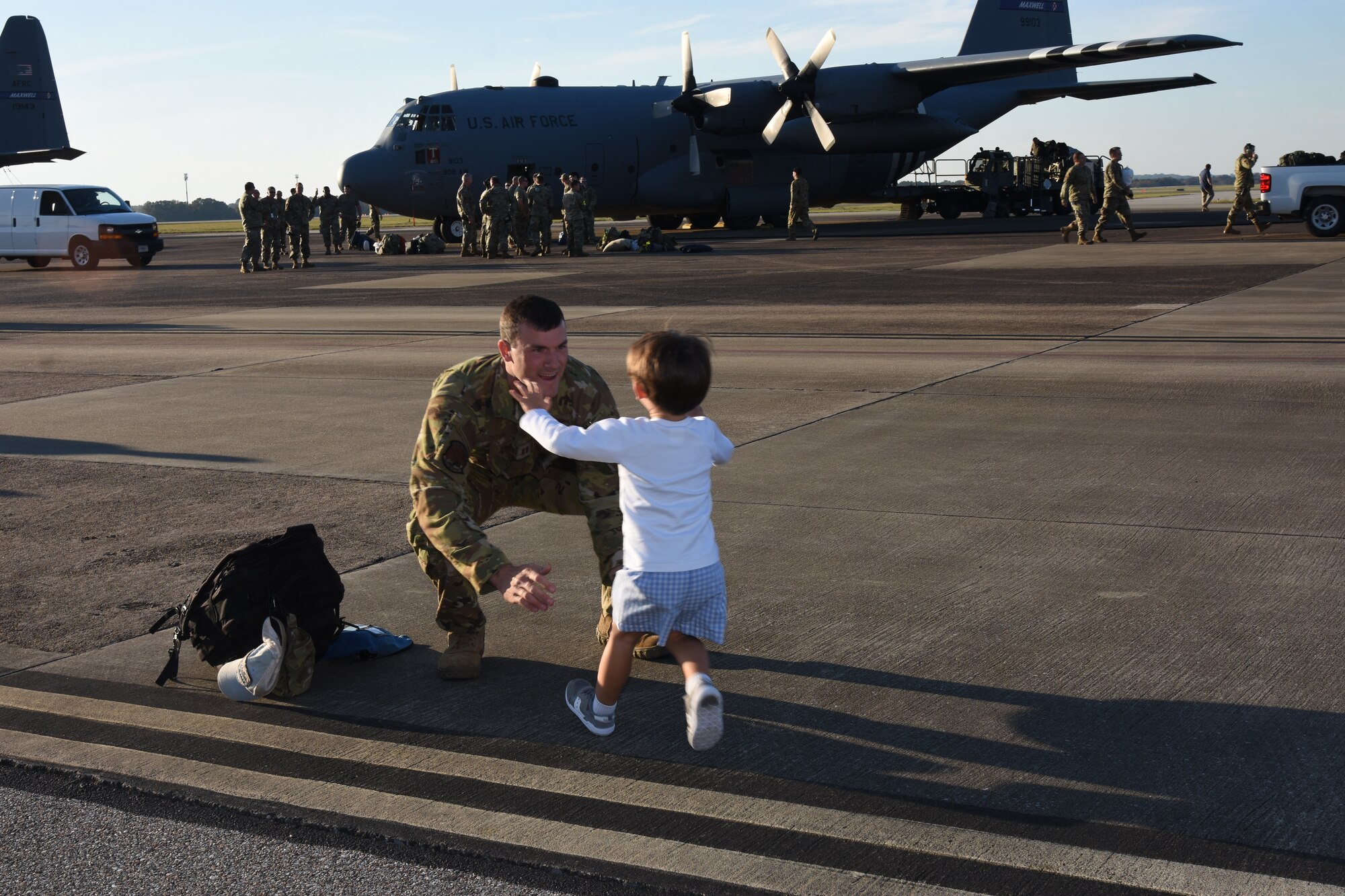 Capt. Drew Tatum, 357th Airlift Squadron pilot, greets his family here Wednesday, 10 November, after returning from a four-month deployment to Southwest Asia.  Tatum was one of nearly 300 908th Airlift Wing Airmen who executed the largest deployment in wing history over the spring and summer of 2021