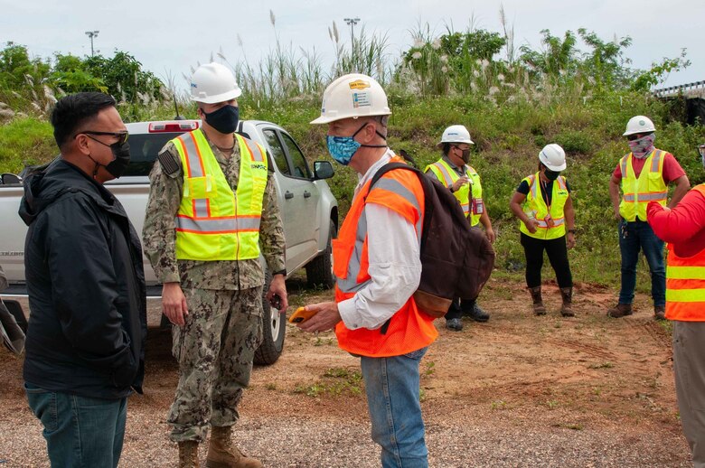 Brian Antolin, Naval Facilities Engineering Systems Command (NAVFAC) Marianas environmental compliance specialist lead at Marine Corps Base (MCB) Camp Blaz, left, and Cmdr. Brian Christner, MCB Camp Blaz public works officer, speak to John Jensen, University of Guam chief hydrogeologist and professor of environmental geology, and Water & Environmental Research Institute Western Pacific director, before a tour of a sinkhole on the installation Oct. 8.