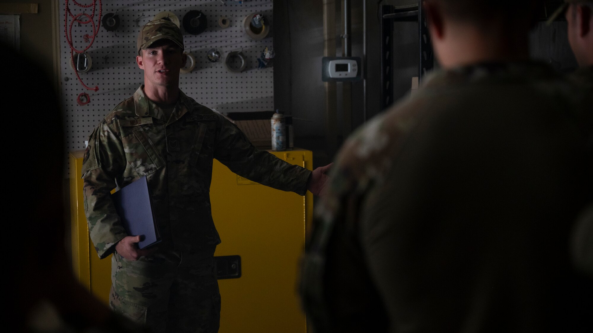 Tech. Sgt. Kraig Hoag, assigned to the 407th Expeditionary Security Forces Squadron, discusses Tactical Combat Casualty Care training scenarios with instructors at Al Jaber Air Base, Kuwait, Nov. 5, 2021.