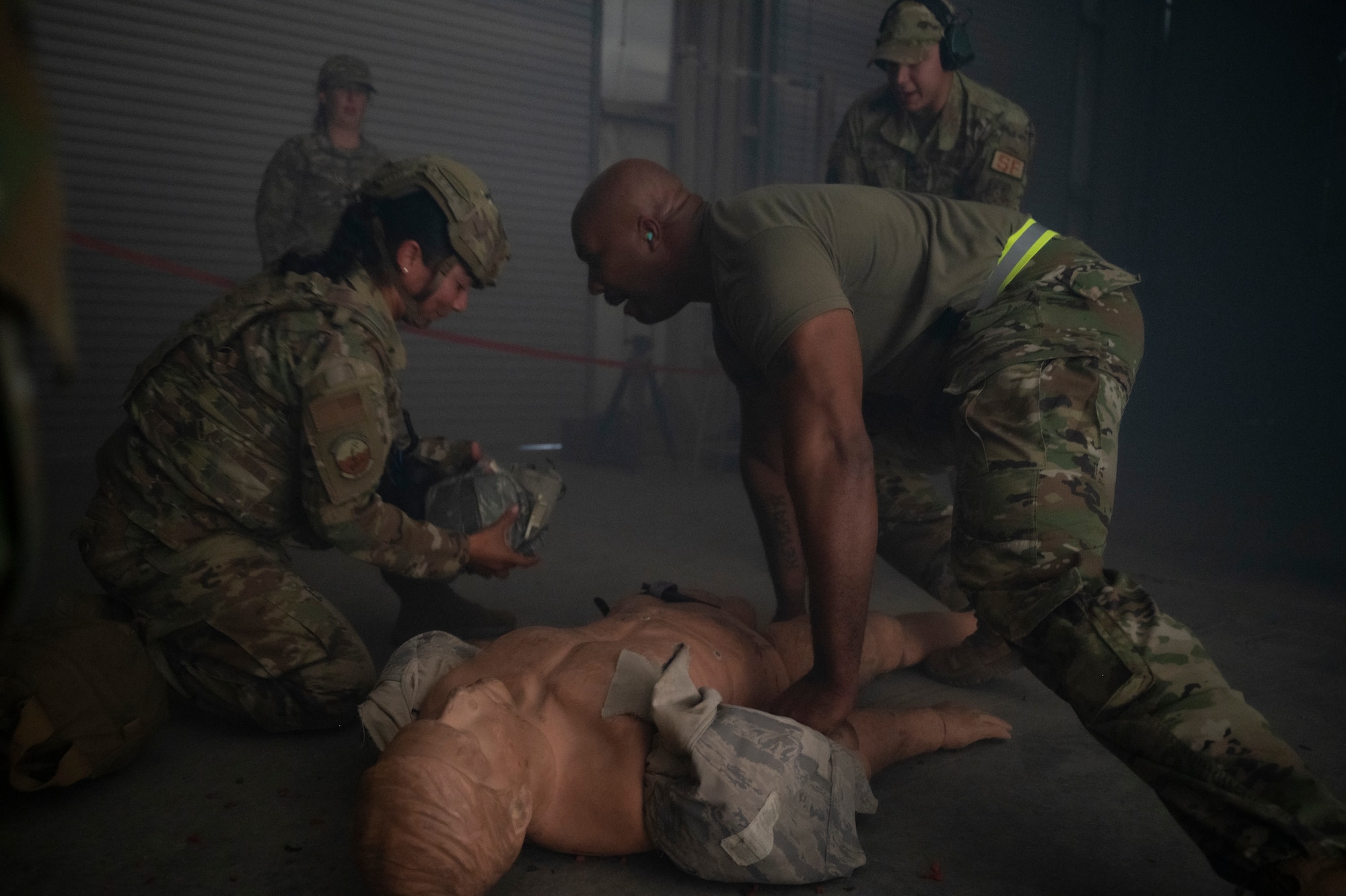 Staff Sgt. John Lundy, assigned to the 407th Expeditionary Security Forces Squadron, attempts to distract Staff Sgt. Jennifer Aleman, assigned to the 386th Expeditionary Security Forces Squadron, during Tactical Combat Casualty Care training at Al Jaber Air Base, Kuwait, Nov. 5, 2021.