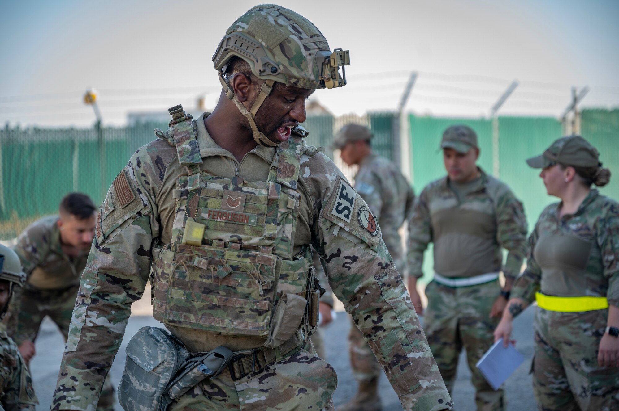 Tech. Sgt. Omari Ferguson, assigned to the 386th Expeditionary Security Forces Squadron, talks to a teammate giving medical aid to a training dummy during Tactical Combat Casualty Care training at Al Jaber Air Base, Kuwait, Nov. 5, 2021.