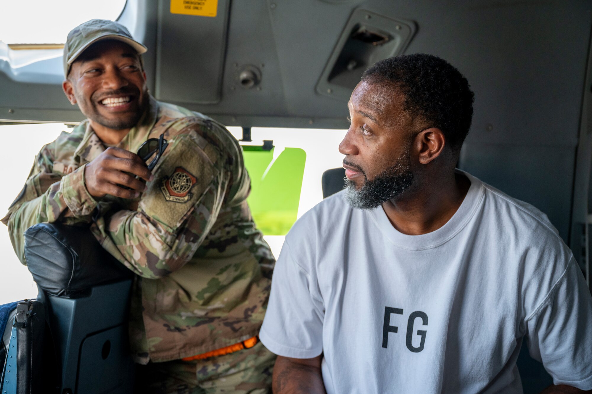 An Airman shows Tracy McGrady the flight deck of a C-17 Globemaster III, Nov. 11, 2021 at Al Udeid Air Base, Qatar.