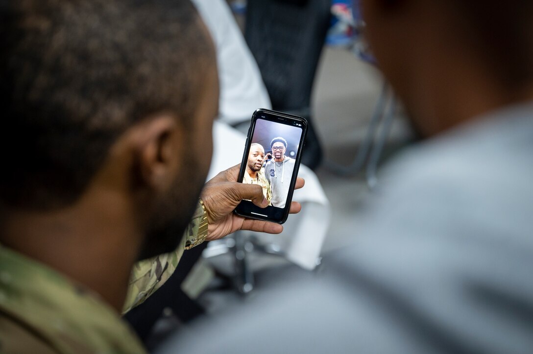 An Airman takes a selfie with Jalen Rose Nov. 11, 2021 at Al Udeid Air Base, Qatar.