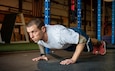 U.S. Air Force Master Sgt. Joshua March, Chaplain Assistant of the 193rd Chaplain Corps, performs a pushup at emPowered Obstacle Barn in Lancaster, Pennsylvania, Nov. 9, 2021. March, a drill status guardsman and a world champion in obstacle course racing, stays fit not only for his events, but for his duty to the United States Armed Forces. (U.S. Air National Guard photo by Airman Diana Snyder)