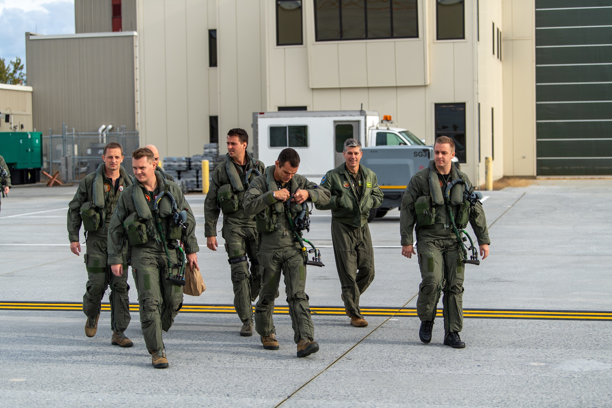 U.S. Air Force Col. Nathan "Wiz" Graber, 158th Operations Group Commander, Vermont Air National Guard, walks onto the flightline with F-35 pilots assigned to the Royal Netherlands Air Force prior to a training mission.