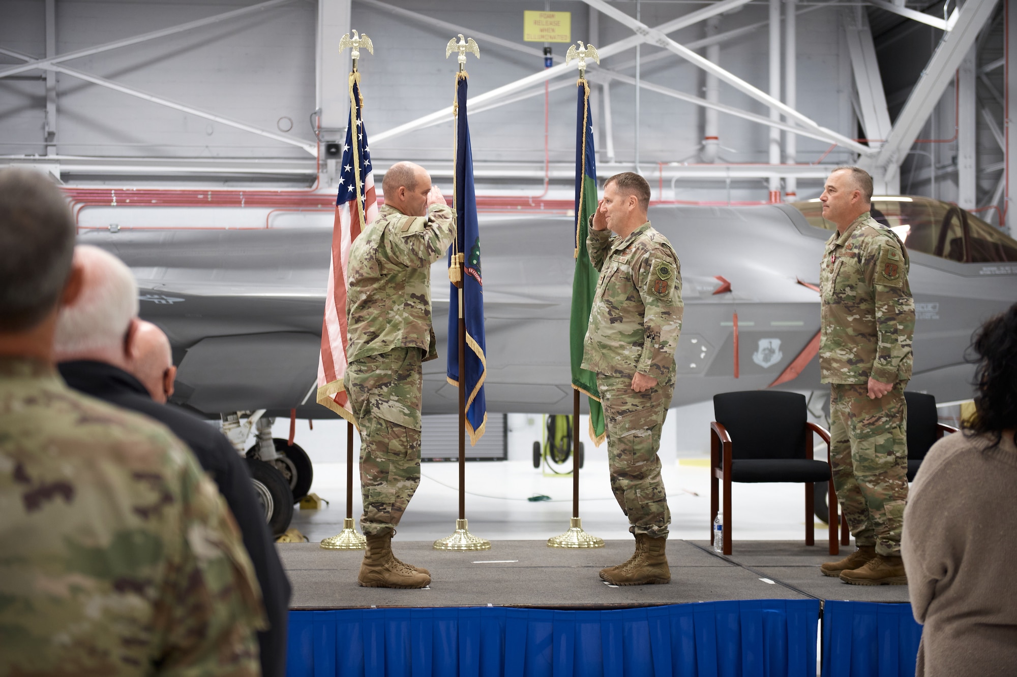 Col. David Shevchik, commander of the 158th Fighter Wing, Vermont Air National Guard, is saluted by Col. Daniel Finnegan as he assumes the role of vice commander during a ceremony where the wing welcomed the new vice commander at South Burlington Air National Guard Base.