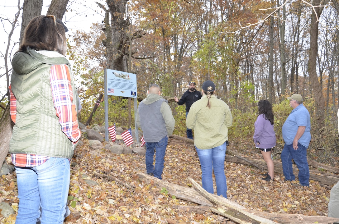 Crowd gathers around a Veterans Day memorial.