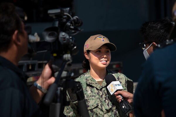 Logistics Specialist Seaman Maria Maglasang, from Guam, assigned to USS Carl Vinson (CVN 70), speaks with local media during a port visit to Guam.