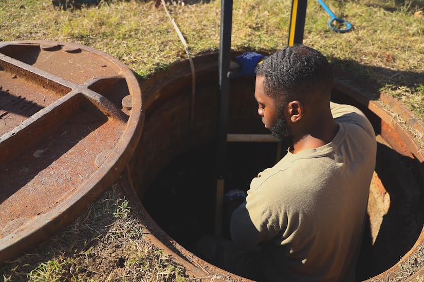 U.S. Air Force Staff Sgt. Andrew Langford, 794th Communications Squadron cable antenna technician, climbs down into a manhole to inspect fiber optic cables at Joint Base Anacostia-Bolling, Washington, D.C., Nov. 9, 2021.  Airmen from the 794th CS cable antenna maintenance are responsible for maintaining all physical and fiber optic structures at JBAB.
By installing and maintaining fiber optics, copper and coaxial lines, cable and antenna systems specialists, ensure the installation has efficient means of communication required to accomplish mission needs. (U.S. Air Force photo by Brian Nestor)