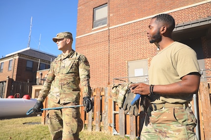 From left, U.S. Air Force Airman Austyn Norris, 794th Communications Squadron cable antenna maintenance technician, and Staff Sgt. Andrew Langford, CS cable antenna technician, prepare to inspect one of the many manholes that contain fiber optic cables used to run communication lines throughout the entire base. 
By installing and maintaining fiber optics, copper and coaxial lines, cable and antenna systems specialists, also known as cable dawgs, ensure the installation has efficient means of communication required to accomplish mission needs. (U.S. Air Force photo by Brian Nestor)