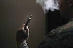 An Airman holds an electronic cigarette at Scott Air Force Base, Illinois, Aug. 13, 2014. The Centers for Disease Control and Prevention is investigating the more than 2,000 cases of e-cigarette, or vaping, product use associated lung injury that have occurred across the country. (U.S. Air Force photo by Airman 1st Class Erica Crossen)