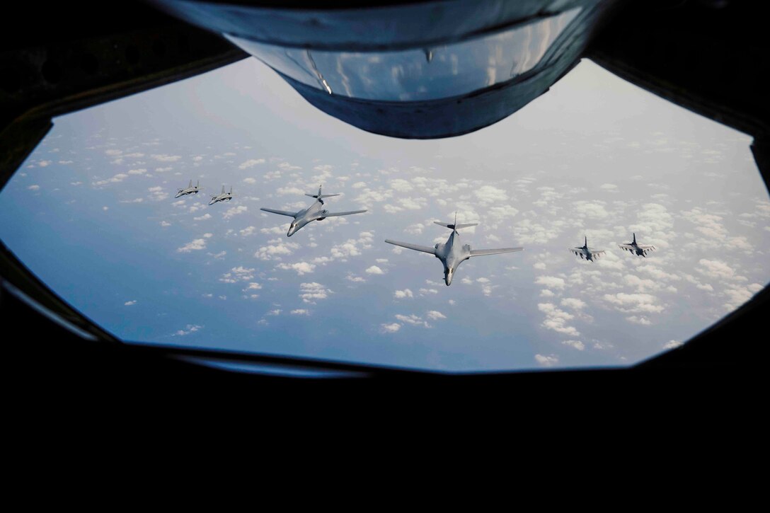 Six aircraft fly in formation.