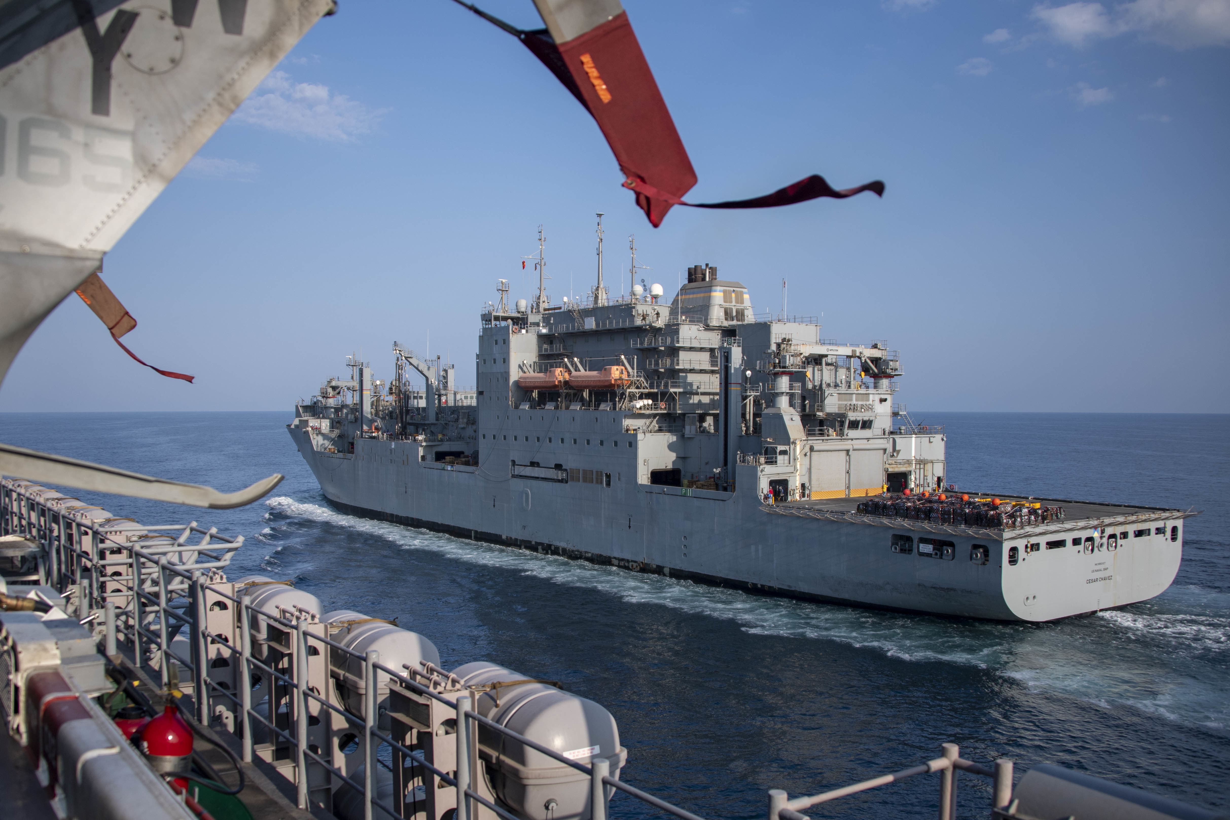 The Dry cargo and ammunition ship USNS Cesar Chavez (T-AKE 14) prepares to go alongside the amphibious assault ship USS Essex (LHD 2) during a replenishment-at-sea.