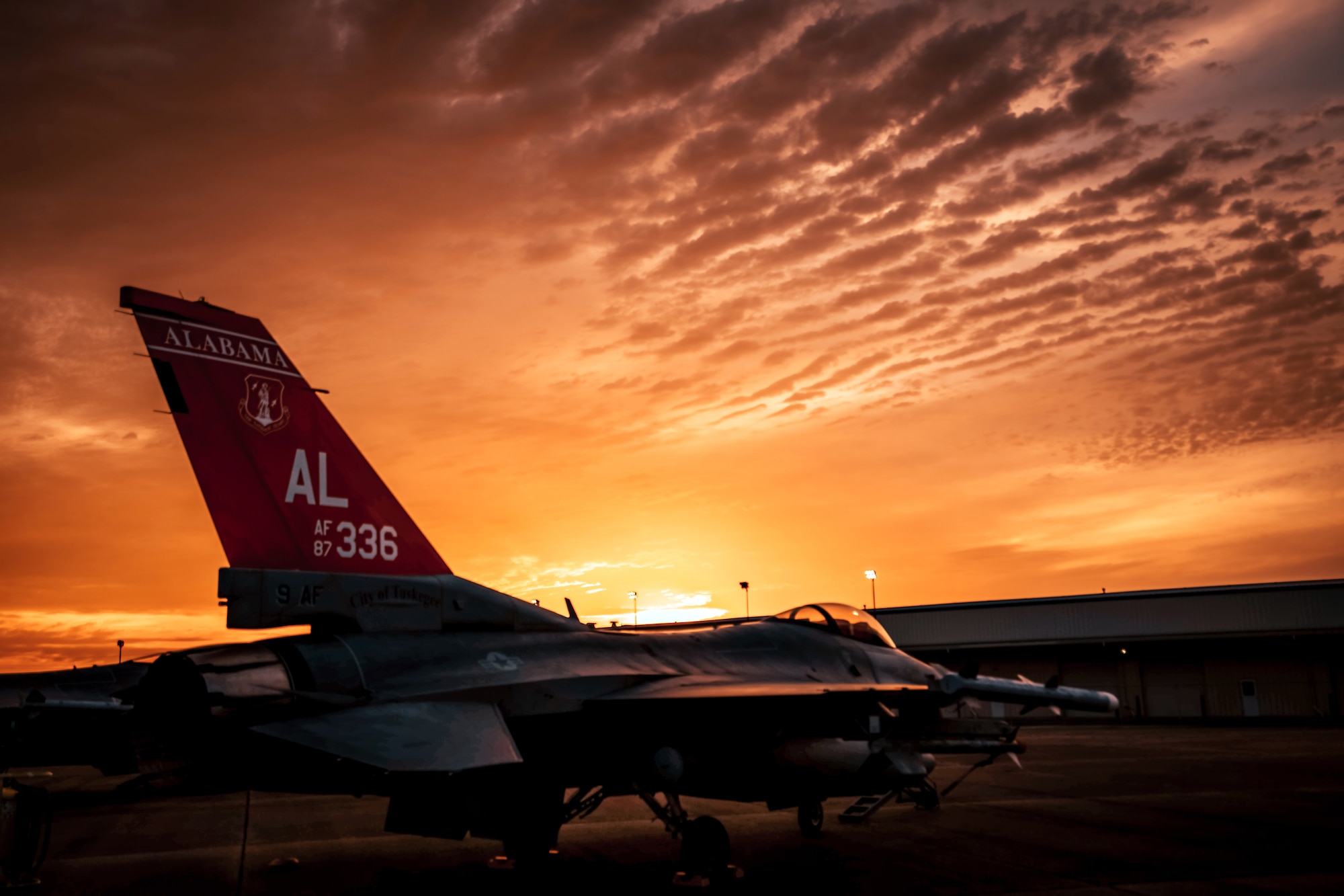 F-16C Fighting Falcon on ground during sunset.