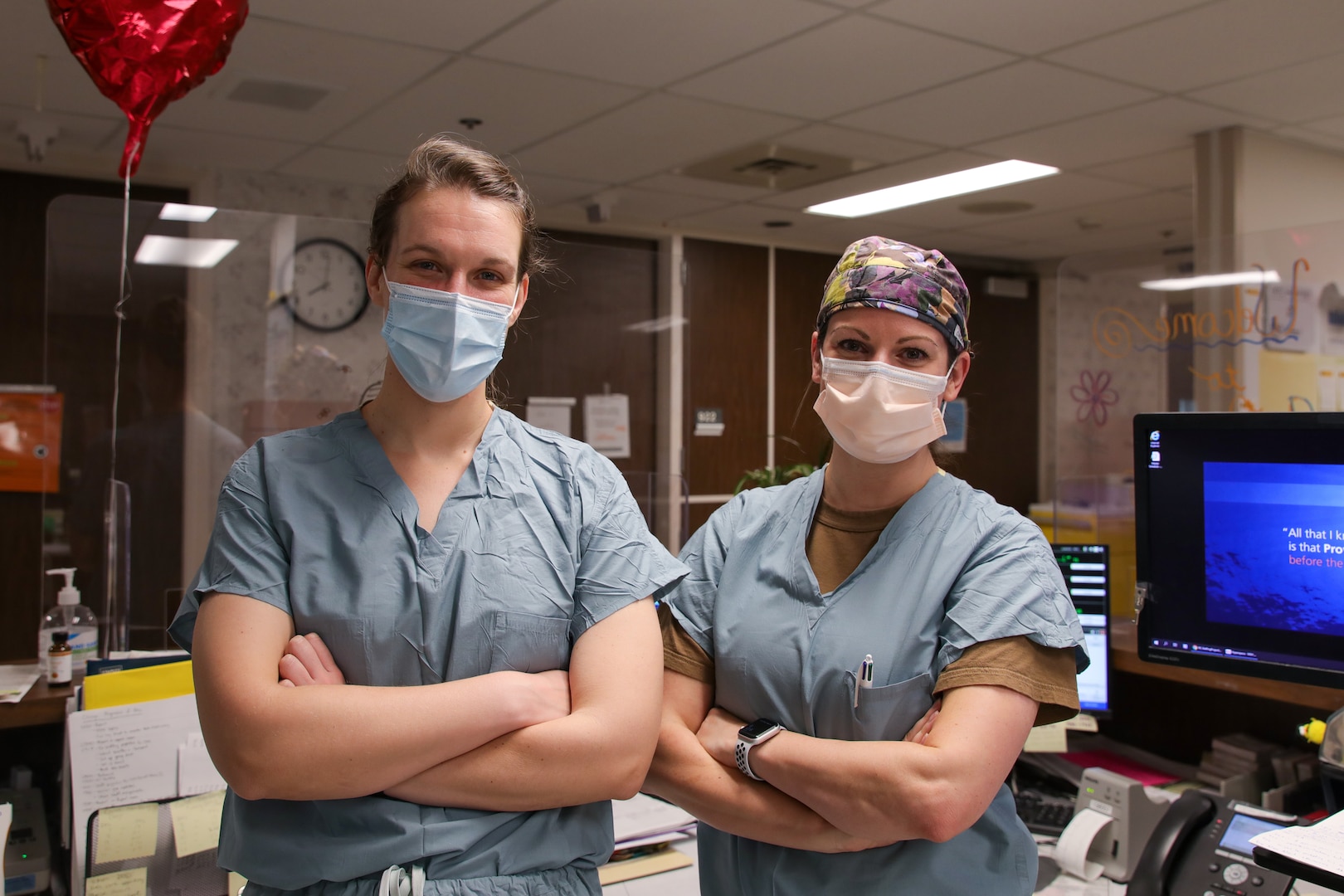 U.S. Navy Lt. Cmdr. Courtney Saint, left, assigned to Navy Medicine Readiness and Training Command, Bremerton, Washington, left, and Lt. Therese Delatorre, right, assigned to NMRTC, Everett, Washington, pose for a photo at Providence Sacred Heart Medical Center in Spokane, Washington, Nov. 8, 2021.