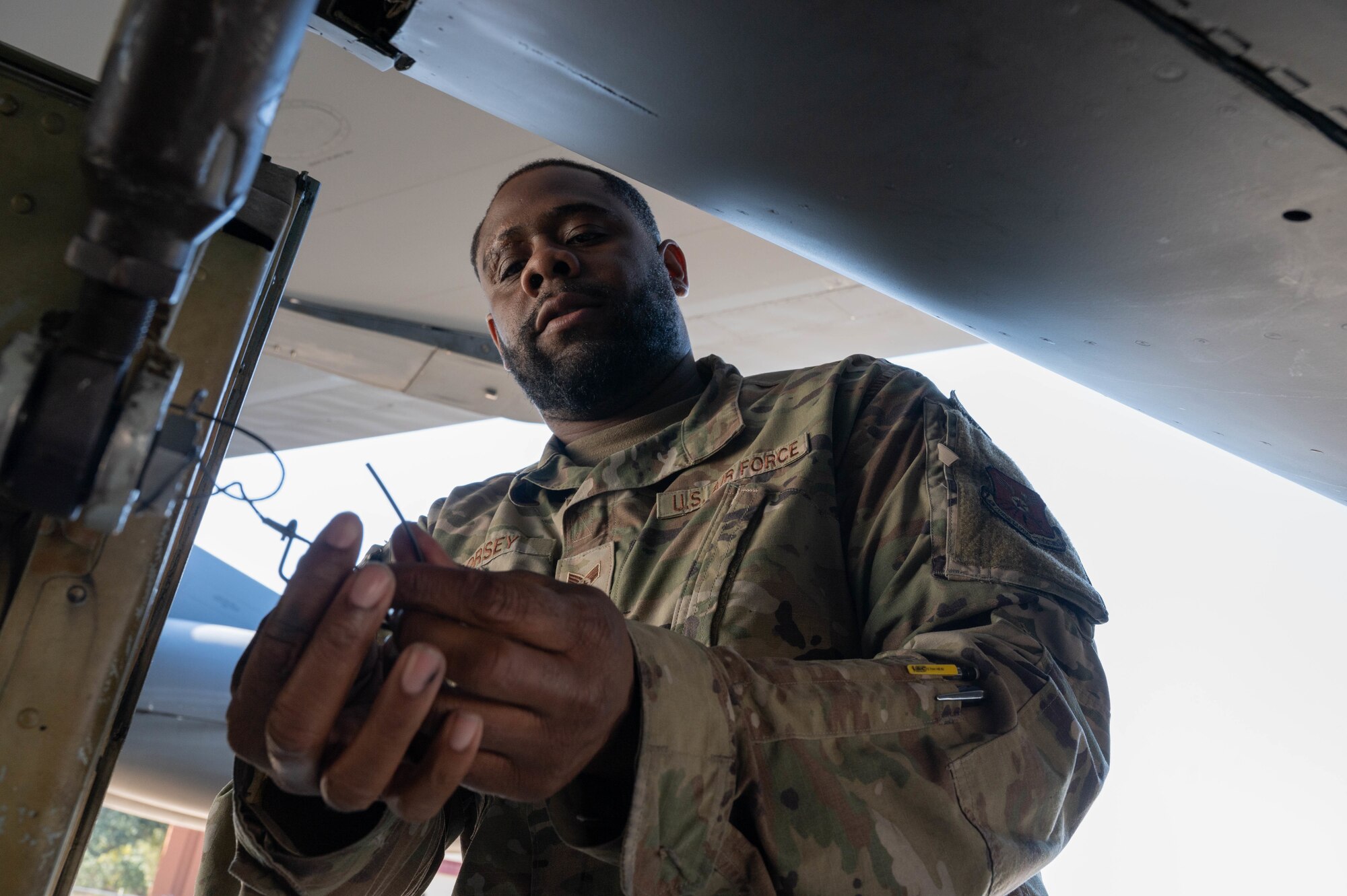 Senior Airman Joe Dorsey, 2nd Aircraft Maintenance Squadron crew chief, removes a safety pin from a B-52 Stratofortress bomb bay door during Global Thunder 22 at Barksdale Air Force Base, Louisiana, Nov. 2, 2021.