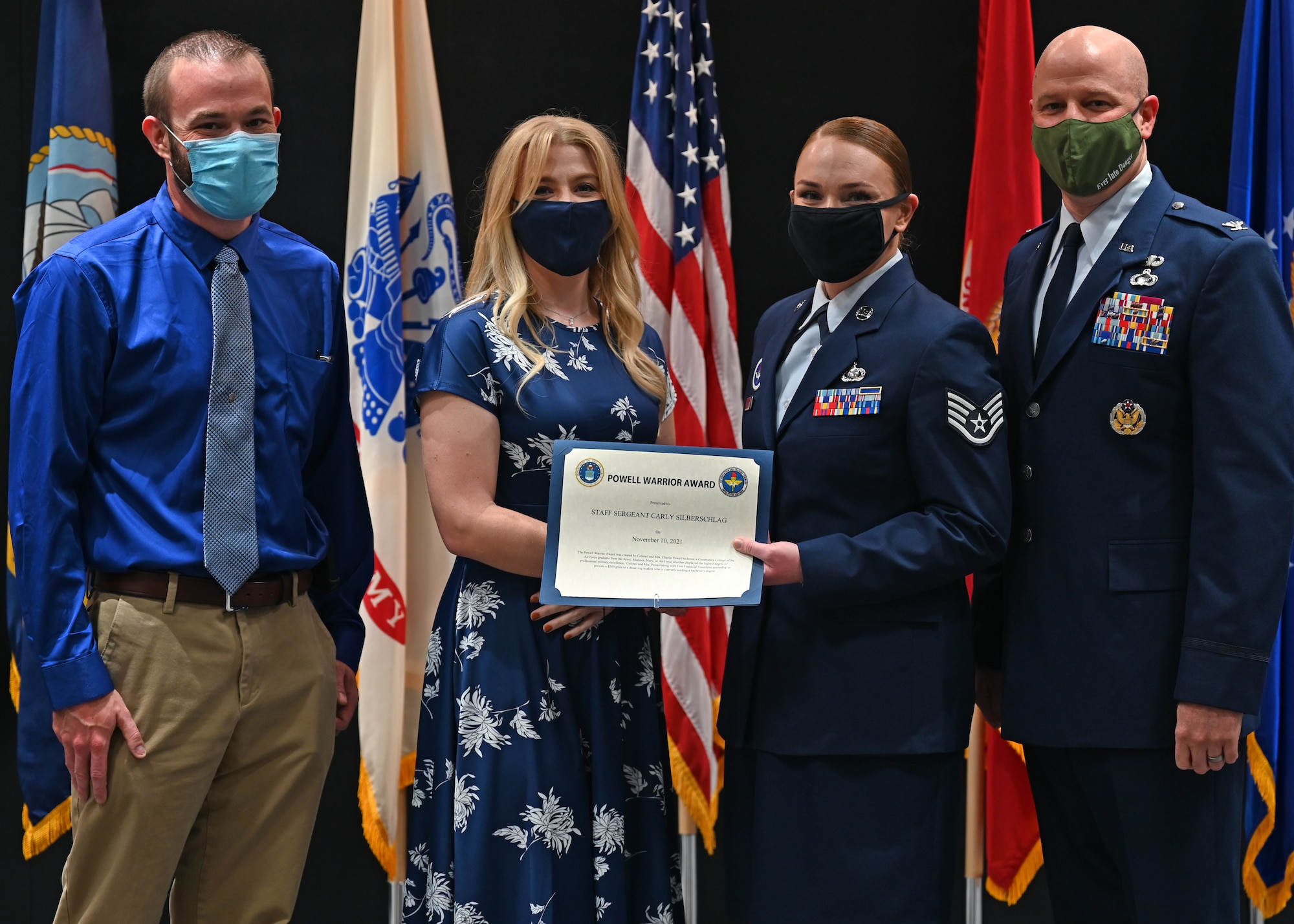 The granddaughter of the late retired Col. Charles Powell, Caitlin Cannady, presented the Powell Warrior Award to U.S. Air Force Staff Sgt. Carly Silberschlag, 316th Training Squadron instructor, at the Community College of the Air Force graduation in the Powell Event Center, Nov. 10, 2021. The award is presented only to CCAF graduates who display the highest degree of military excellence. (U.S. Air Force photo by Senior Airman Ethan Sherwood)