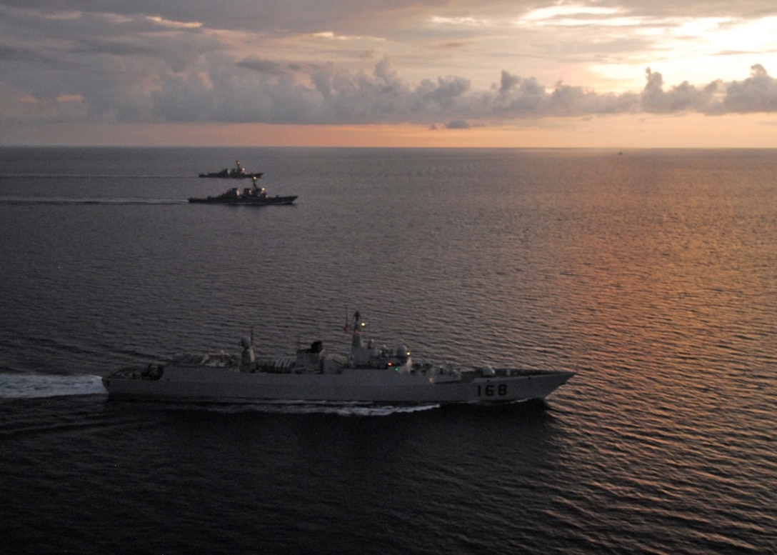 The guided missile destroyers USS Fitzgerald and USS McCampbell maneuver with the Chinese People's Liberation Army Navy destroyer Guangzhou off the coast of North Sulawesi, Indonesia, following an international fleet review that commemorated the 64th anniversary of Indonesian independence. Fitzgerald and McCampbell are part of Destroyer Squadron 15 and the USS George Washington Carrier Strike Group underway supporting security and stability in the western Pacific Ocean.